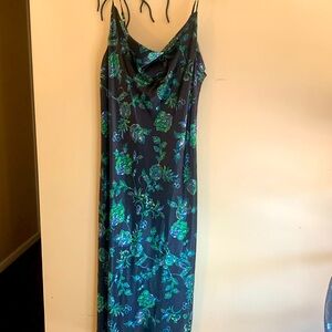 Midi length jewel tone slip dress with adjustable spaghetti straps.